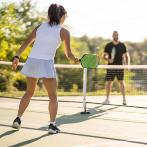 Two people playing pickleball. 